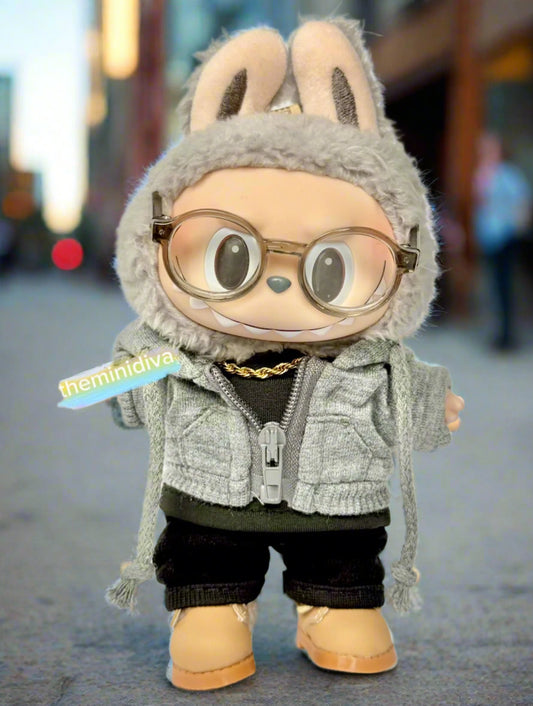 labubu wearing grey sweater with functional zipper and black pants with black shirts and camel boots.